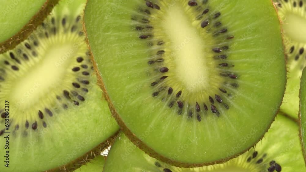 Close up of sliced kiwi fruit on white background. Rotating and dolly video of kiwi. It have juice rich in vitamins and energy. Fresh fruits concept. Close up of sliced kiwi fruit on white background. Rotating and dolly video of kiwi. It have juice rich in vitamins and energy. Fresh fruits concept.