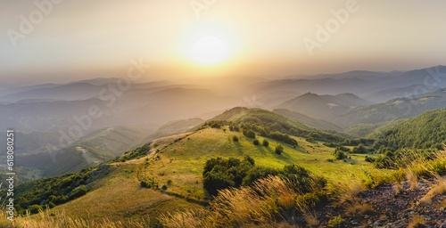 Scenic landscape of rolling hills covered in lush green grass at sunset.