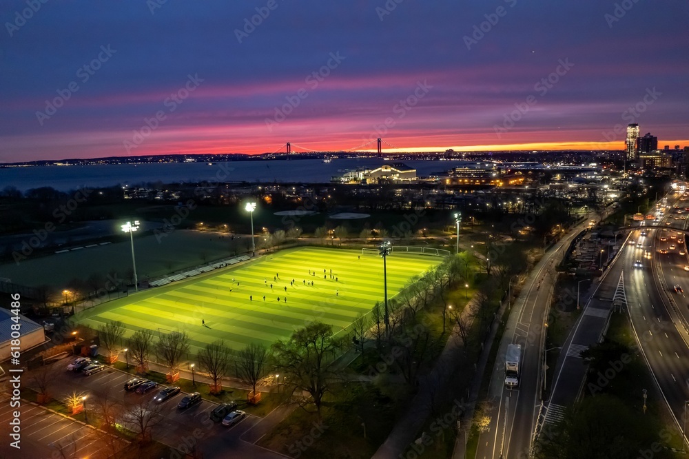 Aerial view of Calvert Vaux Park in Brooklyn, New York during a beautiful and colorful sunset - obrazy, fototapety, plakaty 