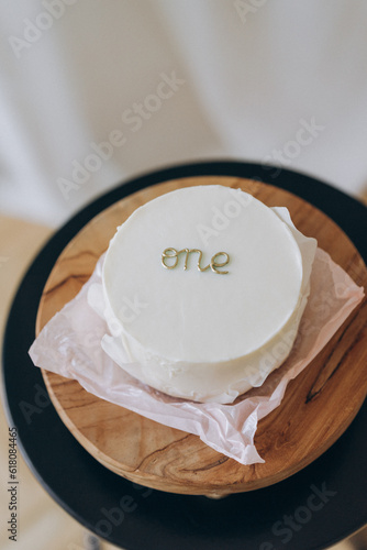 White bento cake for first baby birthday. Birthday girl or boy party decorations. Cake smash