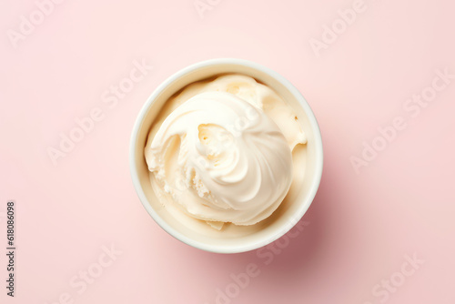 Top view of delicious vanilla milk ice cream in a round white vase isolated on a light pastel pink background. Copy space for text. Generative AI photo.