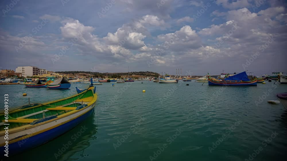 Beautiful and picturesque timelapse of some fishing boats stranded in the sea off the coast of Marsaxlokk, Malta. Beautiful and picturesque timelapse of some fishing boats stranded in the sea off the coast of Marsaxlokk, Malta.