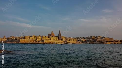 Timelapse of La Valeta coastline in Malta. Shot off the coast with the skyline at sunset. photo