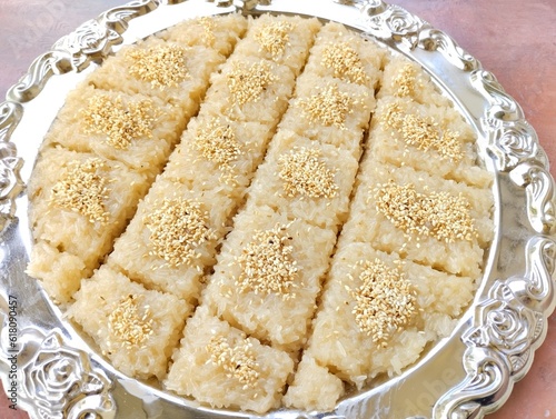 Delicious Thai sweet food traditional dessert stick rice with sugar coconut 