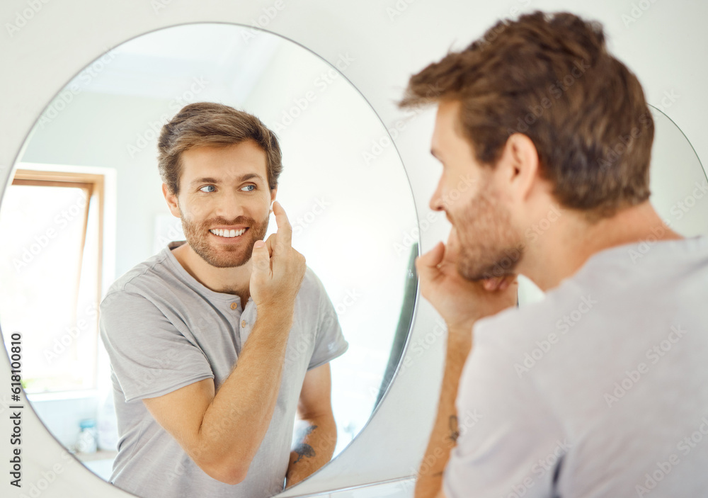 Fototapeta premium Bathroom, mirror and happy man with skincare cream for self care, skin hydration or home beauty treatment. Face cosmetics, dermatology smile or reflection of person with morning sunscreen application