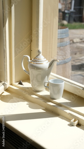 Teapot on the kitchen window (ID: 618103886)
