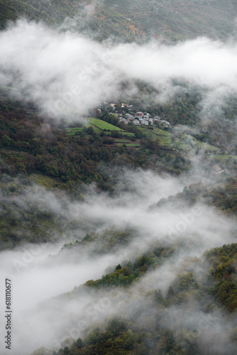 Low clouds parade between chestnut forests and small villages