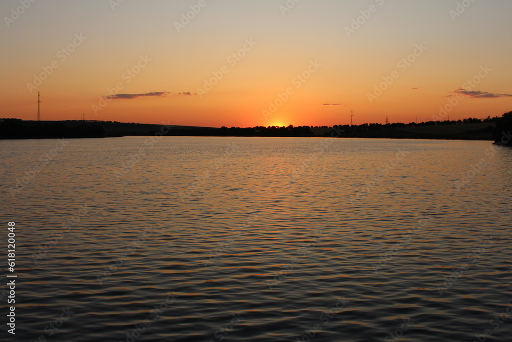 A body of water with land in the background