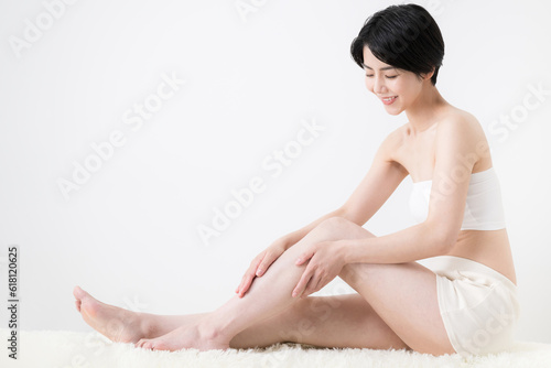 Woman massaging leg thighs, etc. Full body
