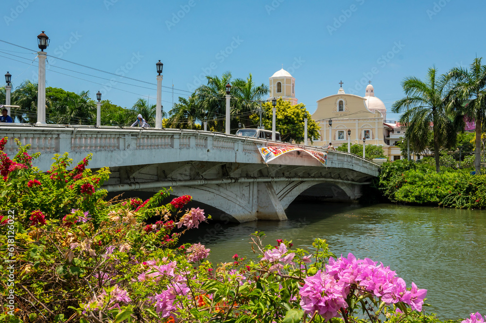 Roxas City, Capiz, Philippines - April 24, 2023: The Capiz bridge spanning the Panay River, and the Roxas Cathedral.