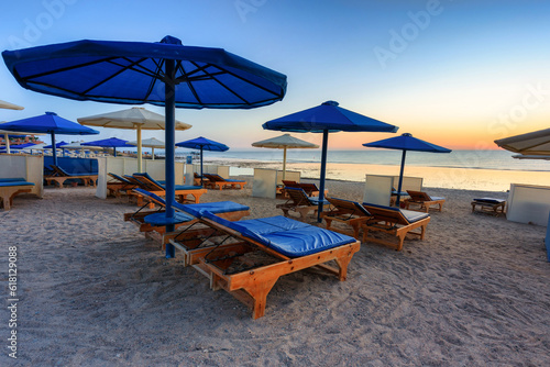 Sun loungers with umbrellas on the beach in Marsa Alam at sunrise  Egypt