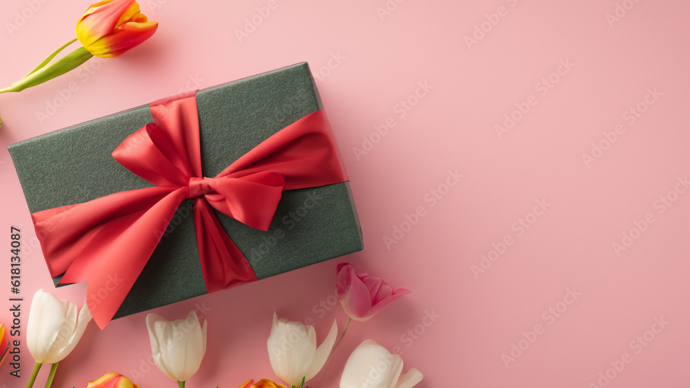 Mothers Day decorations concept. Top view photo of trendy gift boxes with ribbon bows and tulips on isolated pastel pink background with copyspace Mothers Day decorations concept. Top view photo of trendy gift boxes with ribbon bows and tulips on isolated pastel pink background with copyspace
