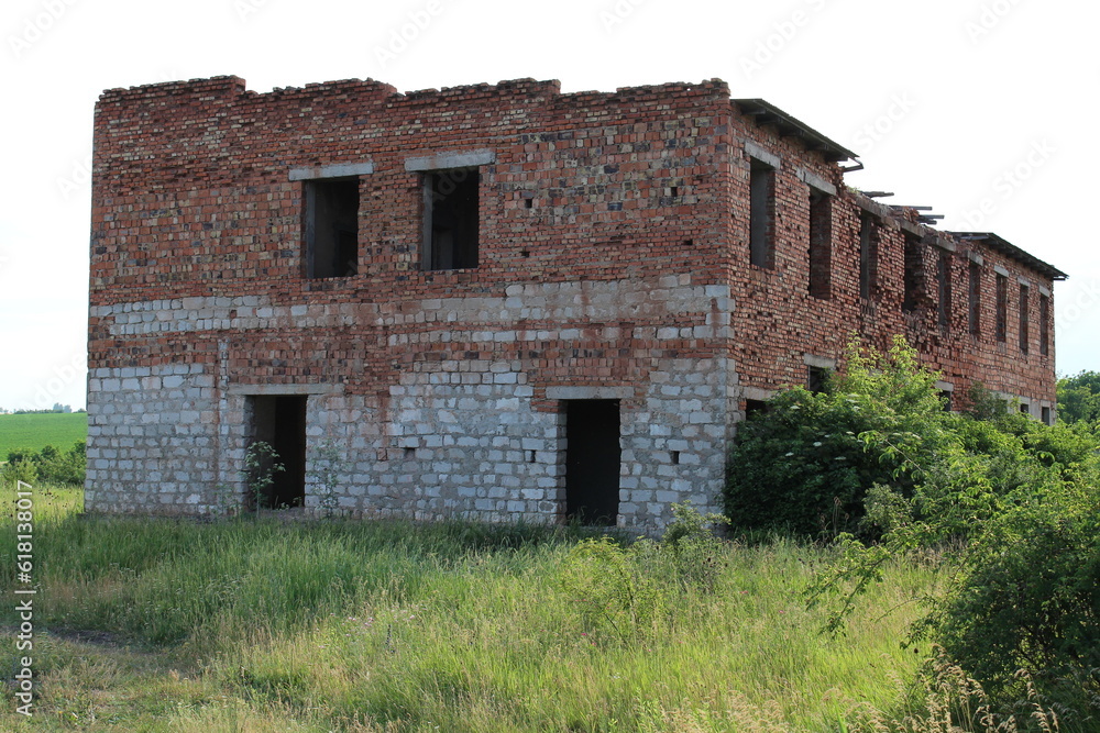 A brick building with grass and bushes A brick building with grass and bushes