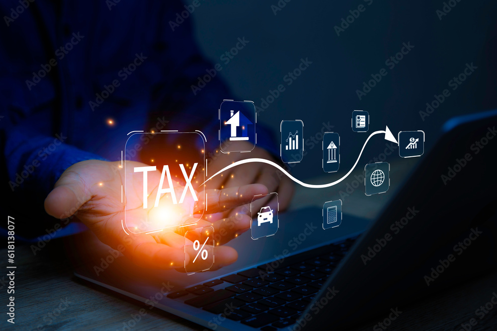 Fotka „Businessman using laptop to fill in the tax online return