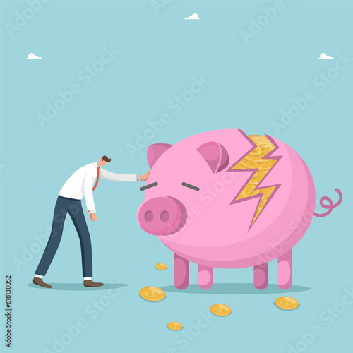Recession and economic crisis, inflation or decrease in the value of money, financial difficulties or bankruptcy, falling currency or stock markets, investment risk, upset man near broken piggy bank.