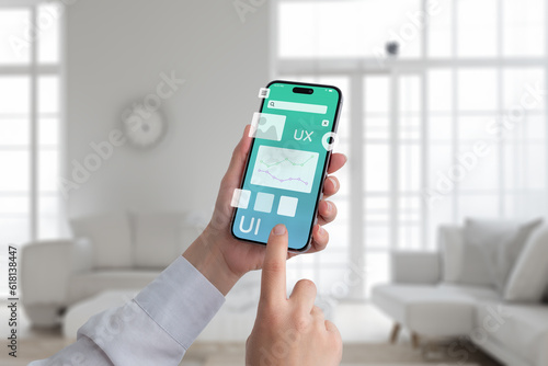 User interface concept. Smart phone in hands with flying app design elements