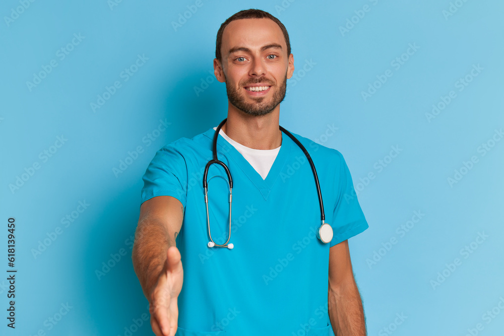 Portrait of a smiling male doctor with stethoscope on blue background. Portrait of a smiling male doctor with stethoscope on blue background.
