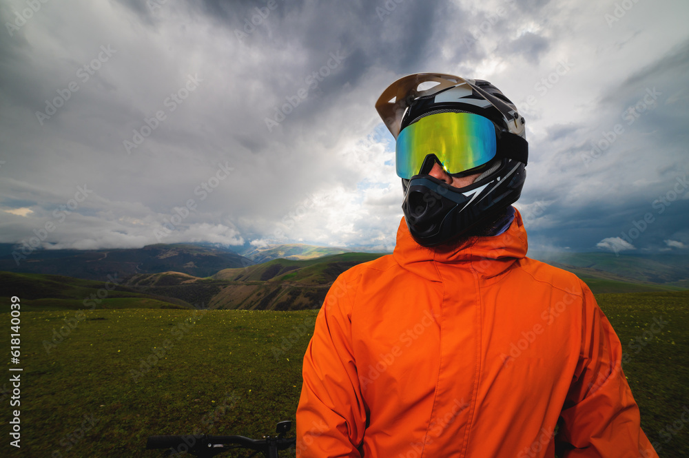 close-up, portrait of a biker in a sports helmet covering the entire face and glasses, the concept of off-road travel by bike, extreme lifestyle close-up, portrait of a biker in a sports helmet covering the entire face and glasses, the concept of off-road travel by bike, extreme lifestyle