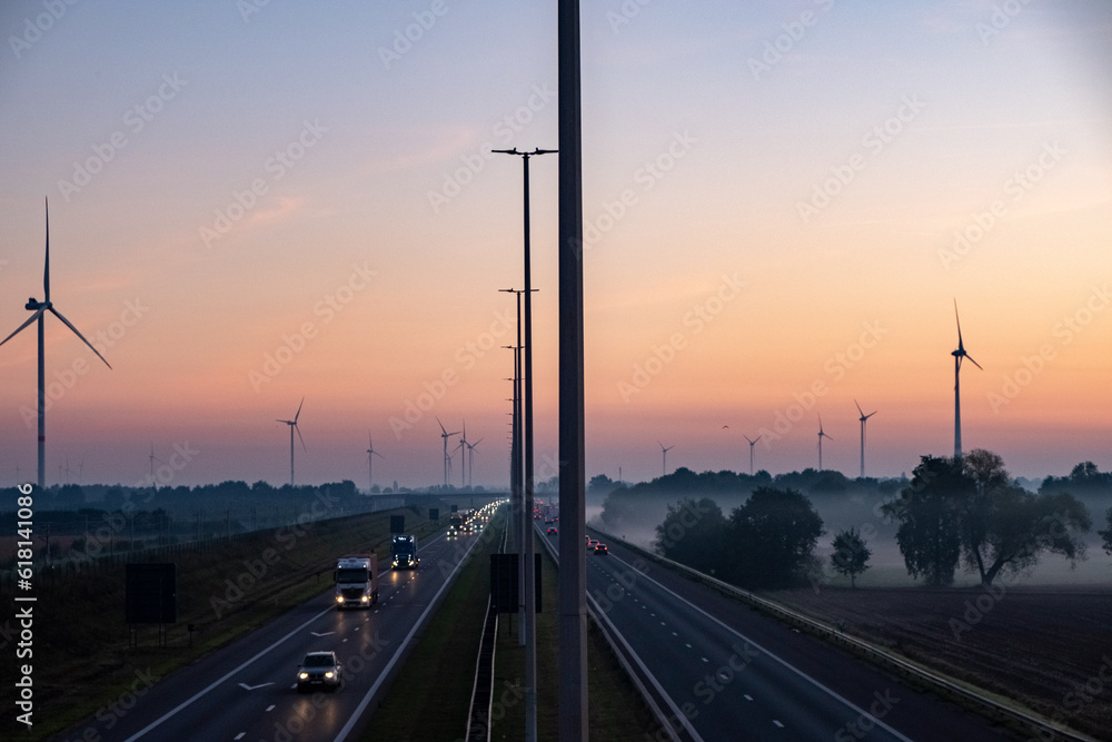 Aerial view of sunrise over a highway with traffic on a light misty morning in Belgium, Europe. High quality photo