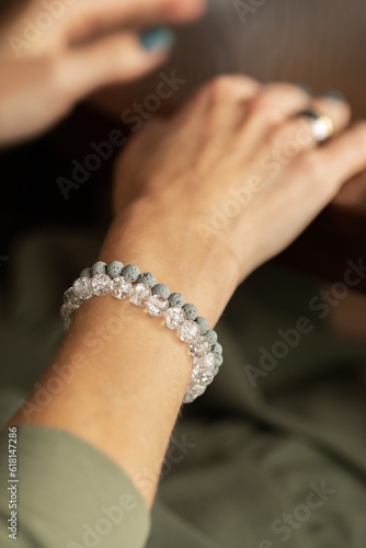 Woman's hand showing off her stacked style bracelet set.