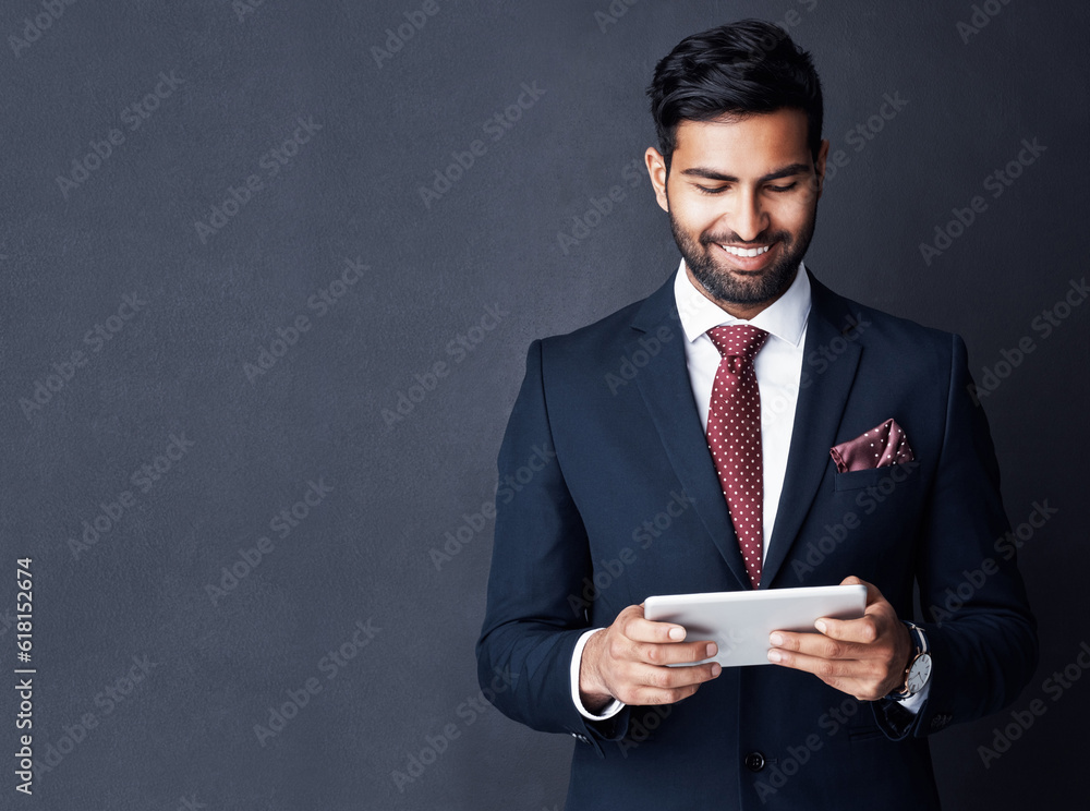 Happy, business man and tablet on dark background in studio with mockup space for trading, planning and internet research. Corporate, indian male trader and smile for digital technology of online app Happy, business man and tablet on dark background in studio with mockup space for trading, planning and internet research. Corporate, indian male trader and smile for digital technology of online app