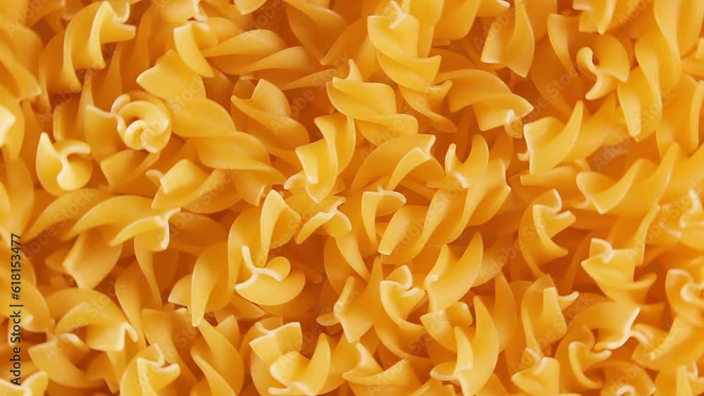 Uncooked Fusilli Pasta - Top View, Close-Up. Fat and Unhealthy Food. Dry Spiral Macaroni, Rotating Background. Italian Culture and Cuisine. Raw Golden Pasta Pattern. Left Rotation Uncooked Fusilli Pasta - Top View, Close-Up. Fat and Unhealthy Food. Dry Spiral Macaroni, Rotating Background. Italian Culture and Cuisine. Raw Golden Pasta Pattern. Left Rotation