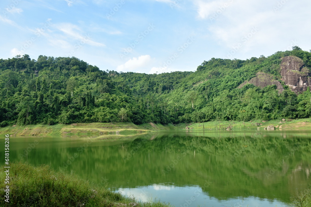 landscape of Klong Klang water reservoir lake with mountain background in Thailand