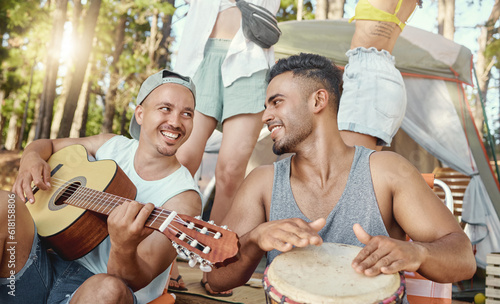 Musician, friends and playing music with guitar and drum on a summer camping, holiday in the woods, forest or nature. Men, happiness and people together for musical performance, song or band photo