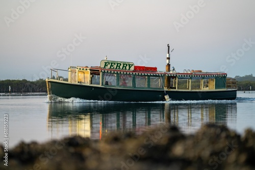 wooden ferry boat on a river crossing at sunset in australia