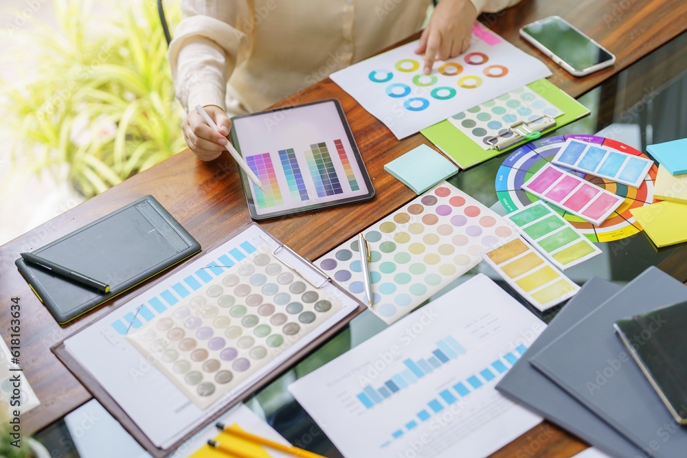 Creative idea Business female Artist Creative Designer sketch graphic drawing on graphic tablet and Color swatch samples Concept of idea creativity. Creative idea Business female Artist Creative Designer sketch graphic drawing on graphic tablet and Color swatch samples Concept of idea creativity.
