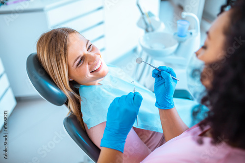 Female dentist working on a female patients teeth in her dental office