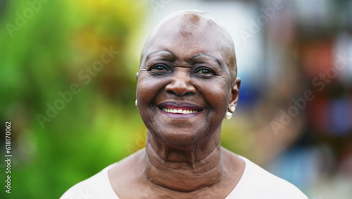 Portrait of an African American senior woman turning head to camera smiling. Close-up of a Brazilian black older woman with joyful expression