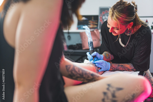 tattoo artist applying ink on a customer's body, tattoo-making process. High quality photo photo