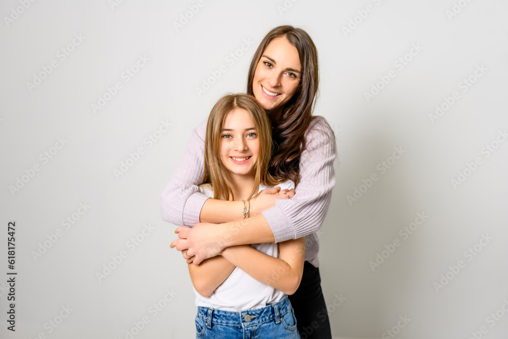 Confident mother and daughter standing in studio Confident mother and daughter standing in studio