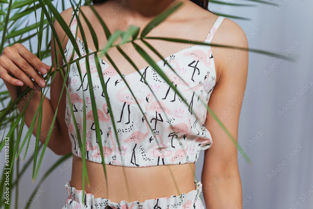 Φωτογραφία details of a nightgown with a flamingo pattern on a girl