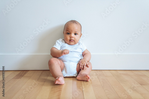 Cheerful baby lay on floor at home