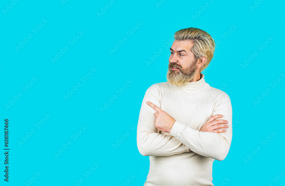 Portrait of attractive glad cheerful man manager demonstrating ad copy space isolated over blue color background. Handsome man with a big smile on face, pointing with hand and finger to the side Portrait of attractive glad cheerful man manager demonstrating ad copy space isolated over blue color background. Handsome man with a big smile on face, pointing with hand and finger to the side