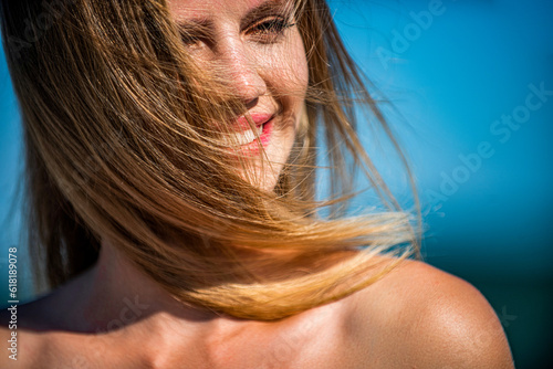 Smiling woman perfect look, bright blond hair. Natural youthful beauty. Woman flying hair enjoying, outdoor. Beauty blonde girl portrait at summer. Woman smiling perfect smile. Perfect hair, shampoo photo