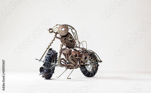 Rusty vintage miniature metal model motorbike on a white background