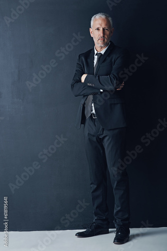 Arms crossed, portrait and business man in studio for professional, corporate or manager. Boss, pride and confidence with face of senior male ceo on black background for executive and mockup space