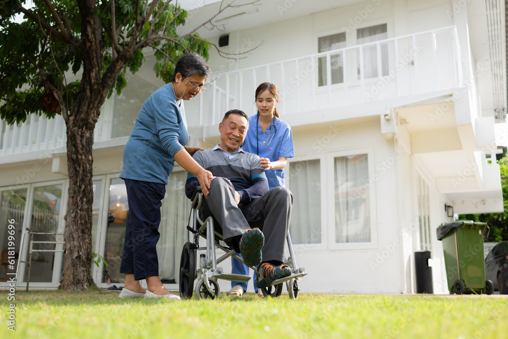 Asian senior man in wheelchair talking with his caregiver at home. Asian senior man in wheelchair talking with his caregiver at home.