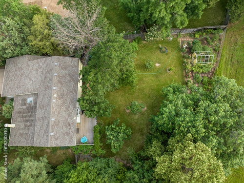 aerial view of a residential house and a green backyard with garden in summer scenery © MarekPhotoDesign.com
