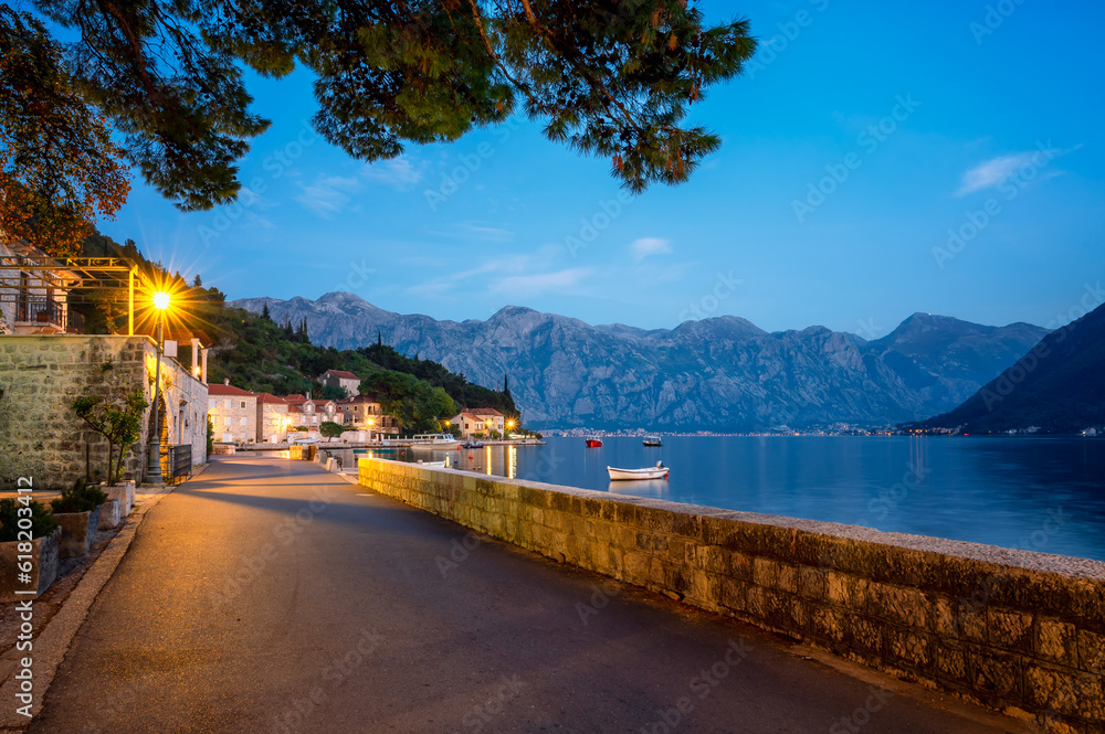 Evening panoramic view of the picturesque town of Perast in the Bay of Kotor with the promenade, beautiful historic buildings and boats, Montenegro.