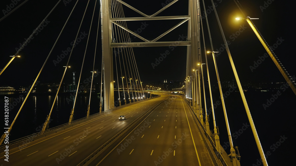 Fototapeta premium Top view elements metal structure modern cable stayed car bridge in night city