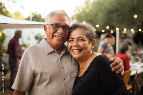 Portrait of a happy smiling senior couple at family gathering outdoors
