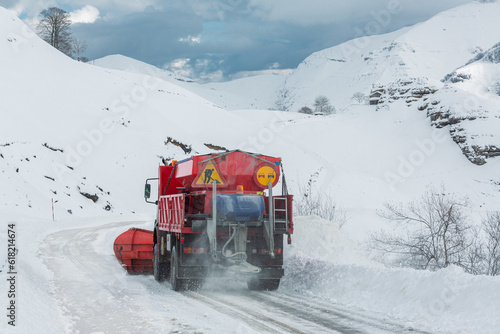 snowplow machine working on a high mountain road