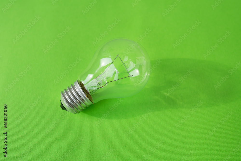 Modern lamp on a green background, light bulb shadow. Modern lamp on a green background, light bulb shadow.