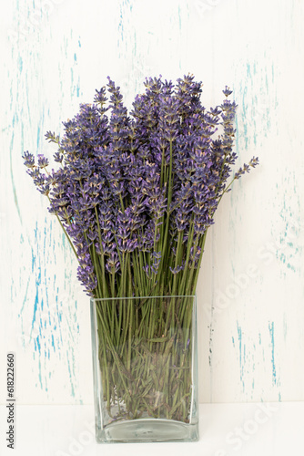 Bouquet fresh lavender flowers in vase on white wooden background