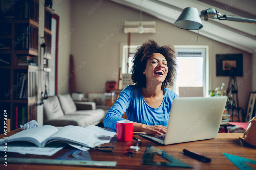 Young woman of african ethnicity studying and using the laptop from home Young woman of african ethnicity studying and using the laptop from home