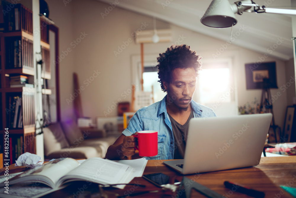 Young man of african ethnicity studying and using the laptop at home Young man of african ethnicity studying and using the laptop at home